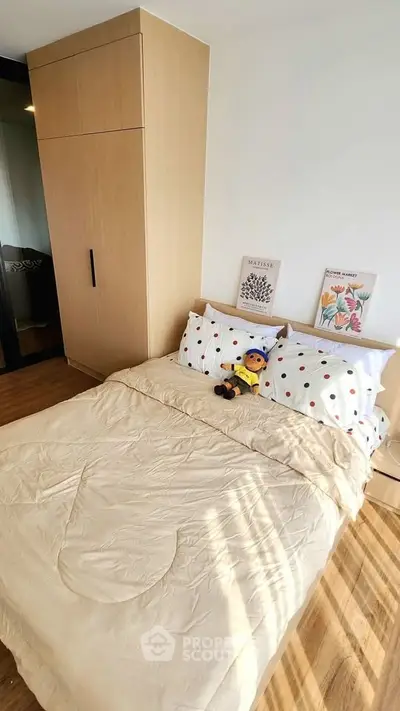 Cozy bedroom with wooden wardrobe and stylish decor, perfect for relaxation.