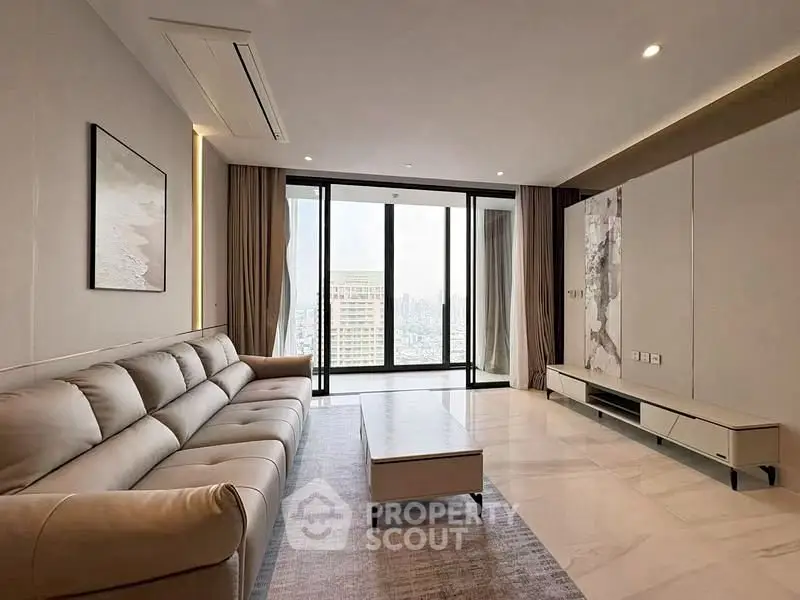 Spacious modern living room with large windows and city view
