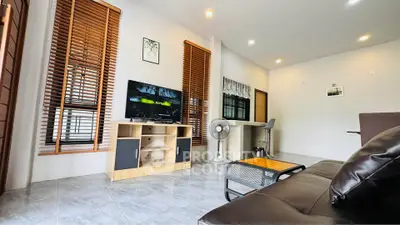 Modern living room with sleek furniture and natural light, perfect for relaxation and entertainment.