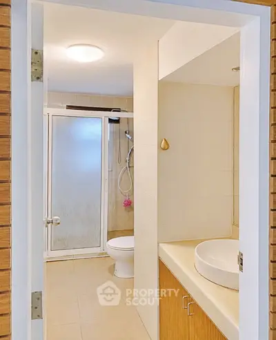 Modern bathroom with shower and stylish sink in a contemporary home.