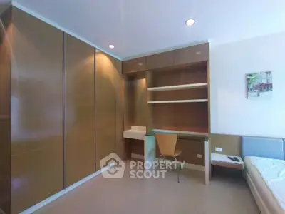 Modern bedroom with built-in wardrobe and study desk, perfect for urban living.