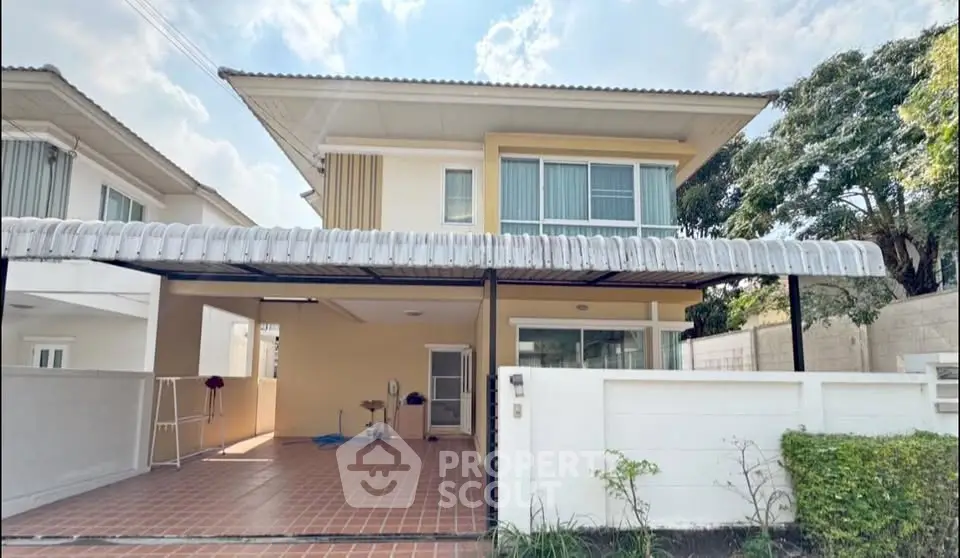 Charming two-story house with spacious carport and modern design