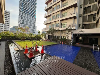 Luxurious condominium with pool and garden in urban setting, perfect for modern living.