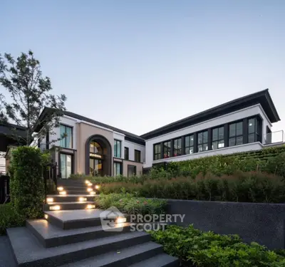 Luxurious modern home with landscaped garden and illuminated pathway