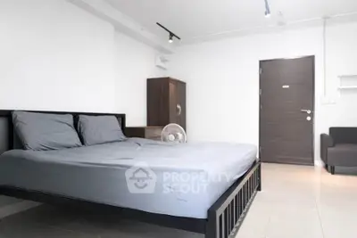 Spacious modern bedroom with minimalist design and sleek furnishings