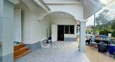 Charming single-story home with spacious front porch and tiled entrance.