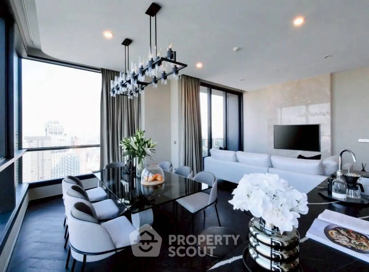 Luxurious modern living room with city view, elegant chandelier, and stylish furnishings.