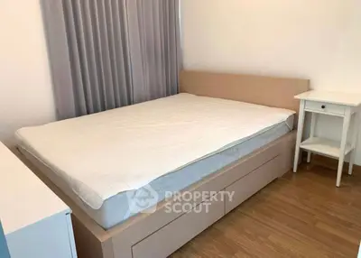 Cozy bedroom with wooden flooring and modern furniture, ideal for a peaceful retreat.