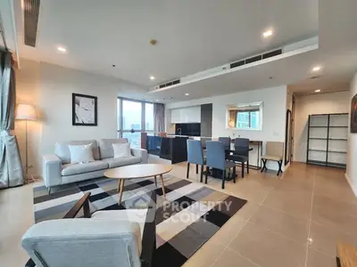 Spacious modern living room with open kitchen and city view, perfect for urban living.