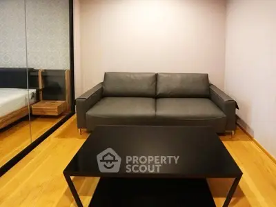 Modern living room with sleek black sofa and minimalist coffee table