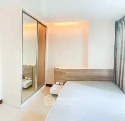 Modern bedroom with mirrored closet and minimalist design