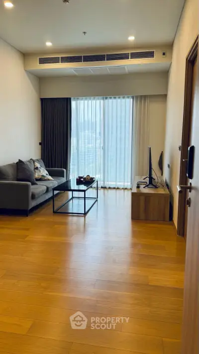 Spacious living room with modern decor and large window view
