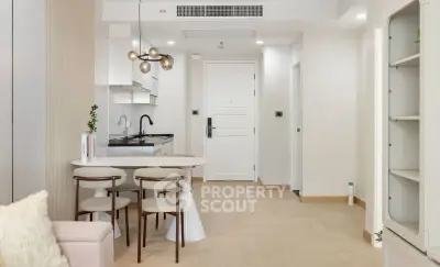 Modern open-layout kitchen and dining area with stylish lighting and minimalist design.
