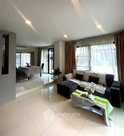Spacious living room with modern decor and natural light