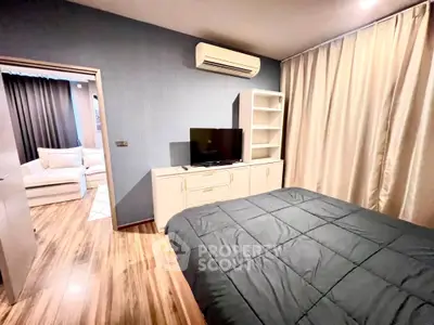 Modern bedroom with sleek design, featuring air conditioning and stylish wooden flooring.