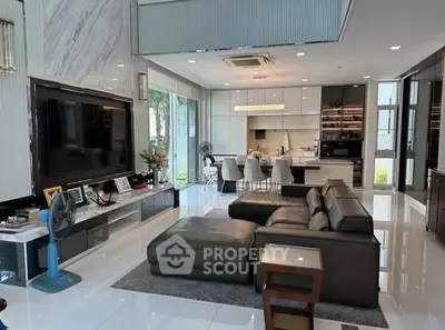 Luxurious open-plan living room with modern kitchen and elegant decor, perfect for stylish urban living.