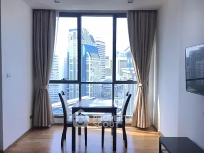 Modern dining area with city view, featuring floor-to-ceiling windows and elegant curtains.