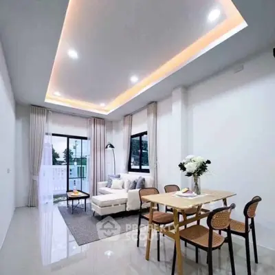 Modern living room with stylish ceiling lights and cozy furniture, perfect for relaxation and entertaining.