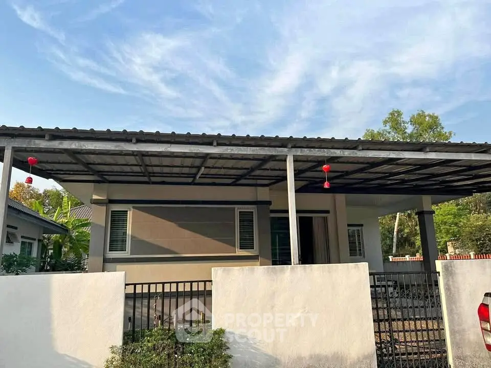 Charming single-story home with covered carport and modern facade under a clear blue sky.