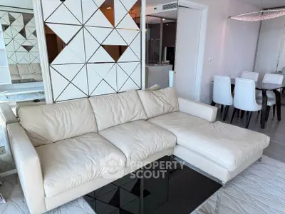 Modern living room with stylish white sofa and geometric wall design