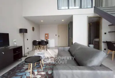 Modern living room with sleek furniture and open layout in a stylish apartment.