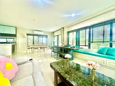 Spacious living room with modern decor and large windows offering natural light