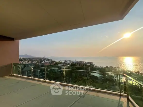 Stunning ocean view from spacious balcony at sunset, perfect for relaxation.