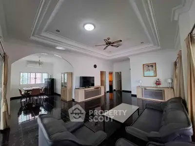 Spacious living room with elegant decor and modern furniture, perfect for family gatherings.