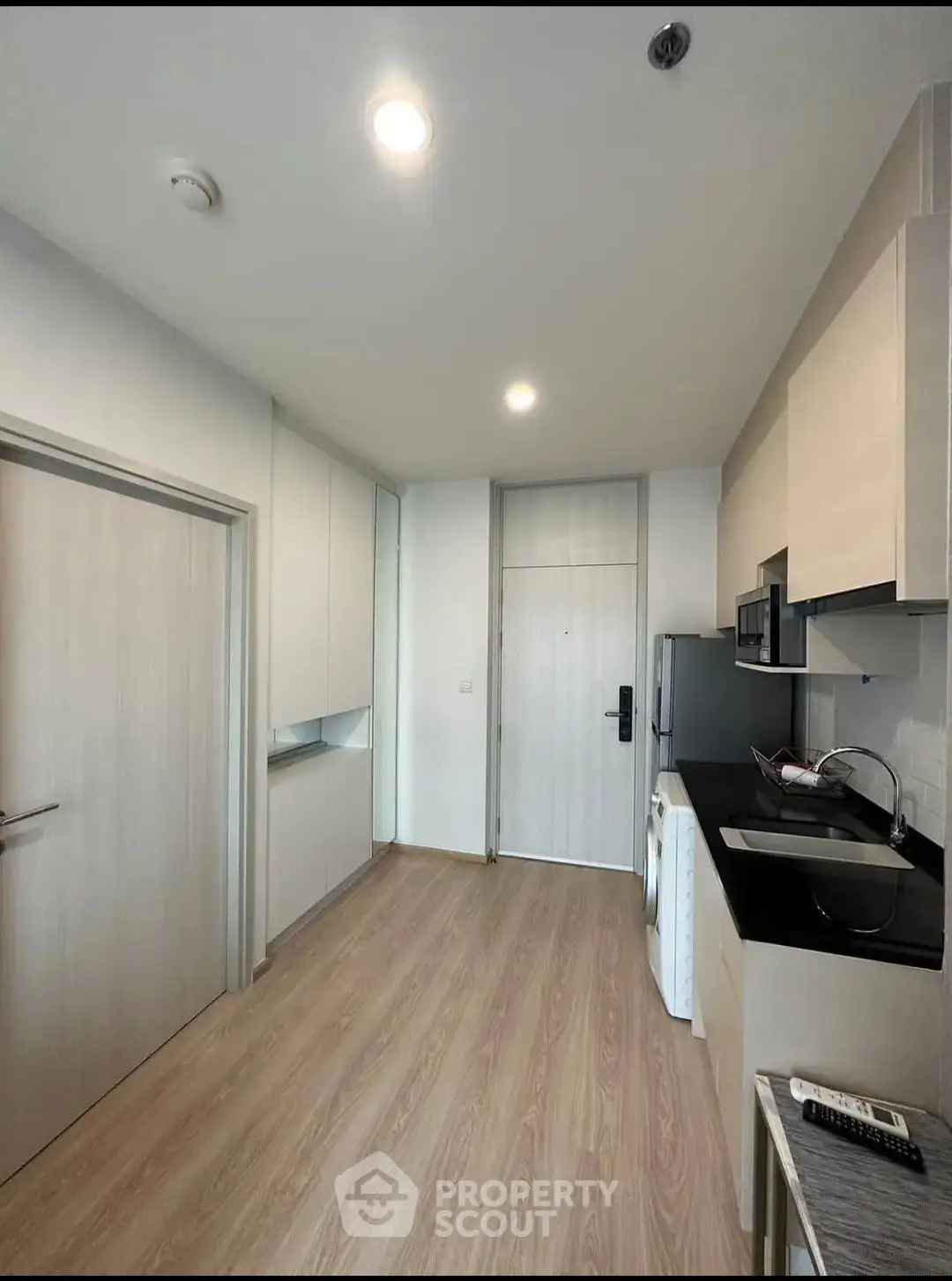 Modern kitchen with sleek cabinetry and built-in appliances in a compact layout.