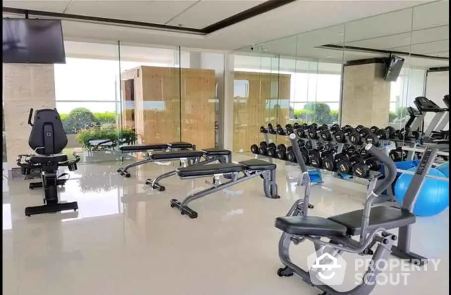 Luxurious gym with modern equipment and scenic views, perfect for fitness enthusiasts seeking a premium workout space.