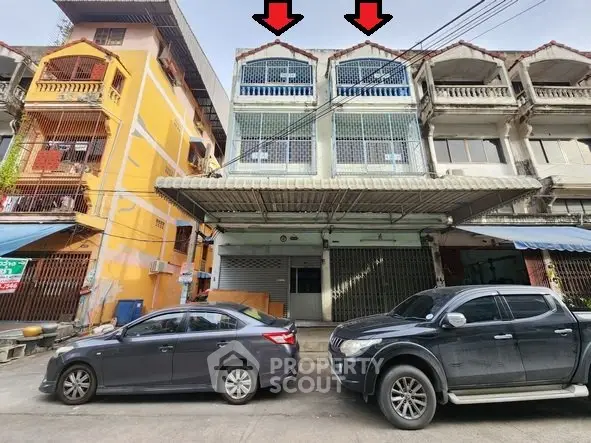 Commercial building exterior with parking space in urban area, ideal for business opportunities.