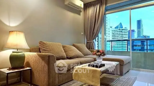Modern living room with city view, featuring cozy sofa and elegant decor.