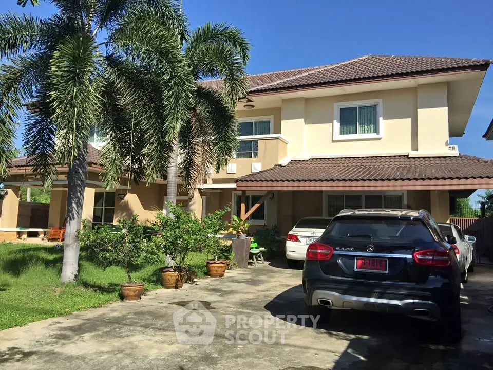 Charming two-story house with lush garden and spacious driveway, perfect for family living.