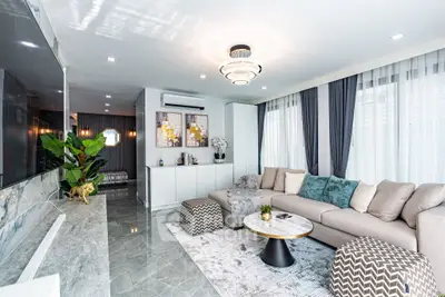 Luxurious modern living room with elegant decor and ample natural light.