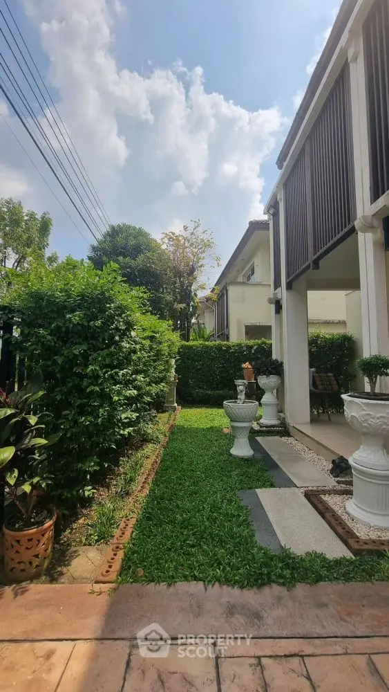 Charming garden view with lush greenery and elegant outdoor decor in a modern residential property.