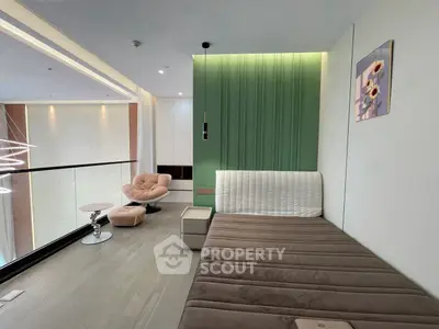 Modern living room with stylish furniture and green accent wall, featuring a cozy seating area and elegant decor.
