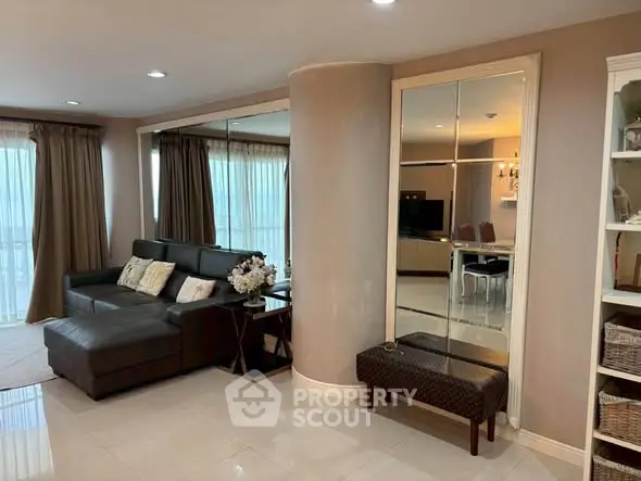 Spacious living room with modern decor and large windows in a stylish apartment.