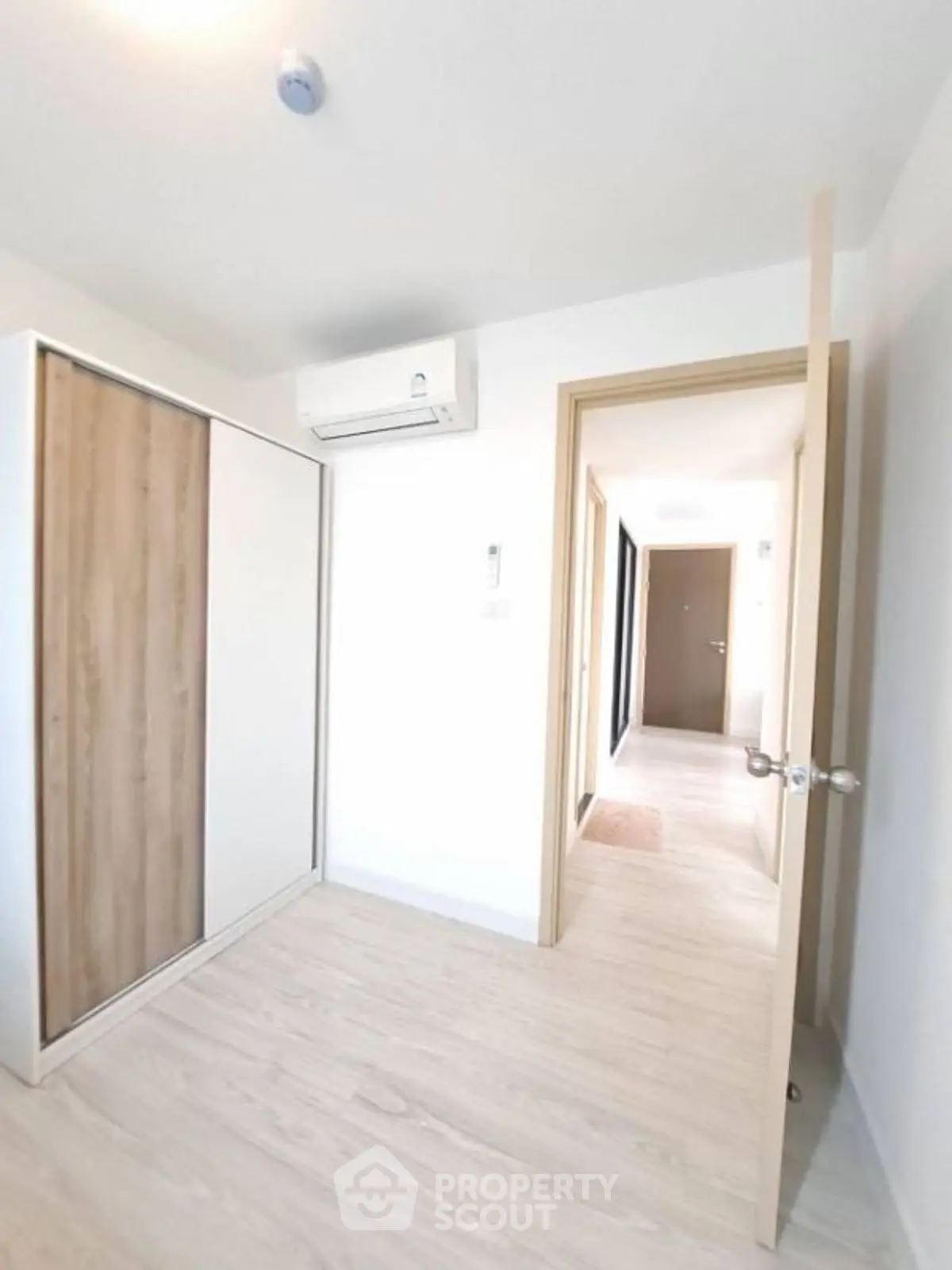 Bright minimalist room with wooden closet and air conditioning