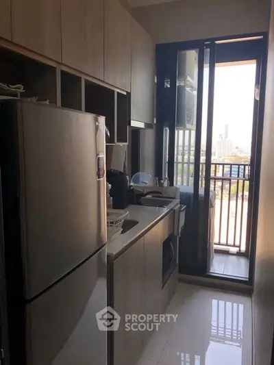 Modern kitchen with sleek appliances and city view balcony