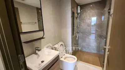 Modern bathroom with sleek fixtures and spacious shower area