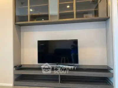 Modern living room with sleek TV stand and glass cabinets, perfect for stylish entertainment setup.
