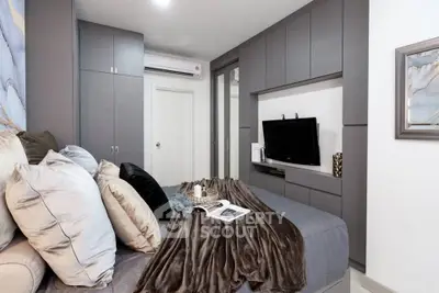 Cozy bedroom with modern decor and built-in storage solutions.