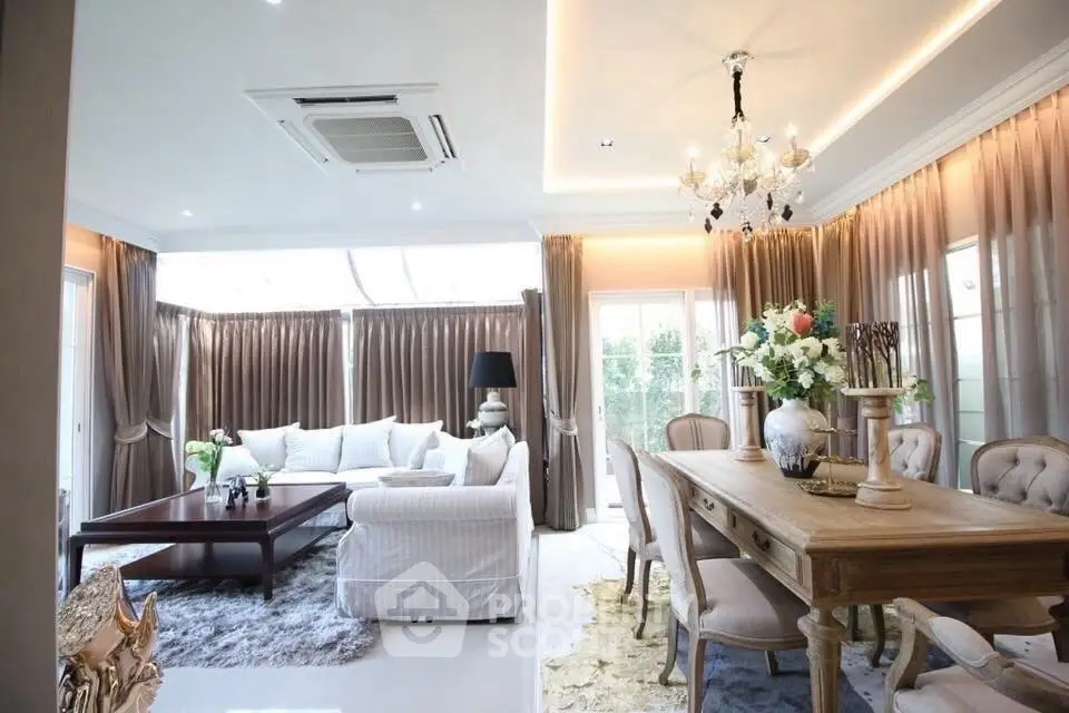 Luxurious living and dining area with elegant decor and natural light