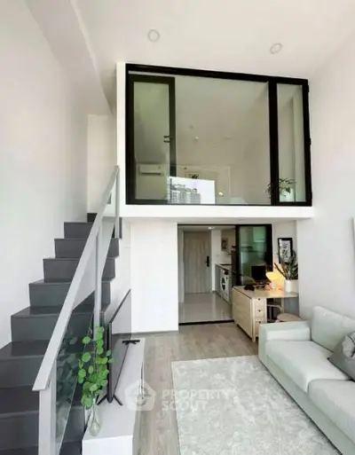 Modern loft apartment with mezzanine, sleek staircase, and cozy living area.