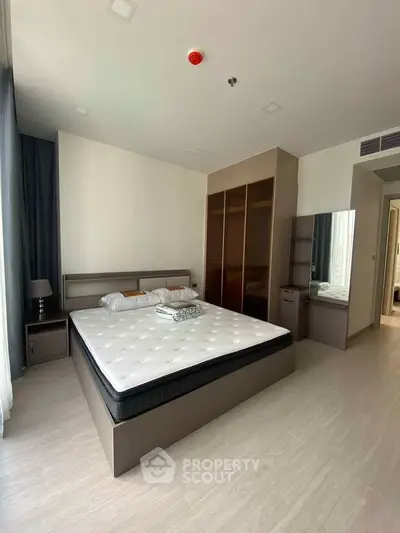 Spacious bedroom with modern furnishings and ample natural light