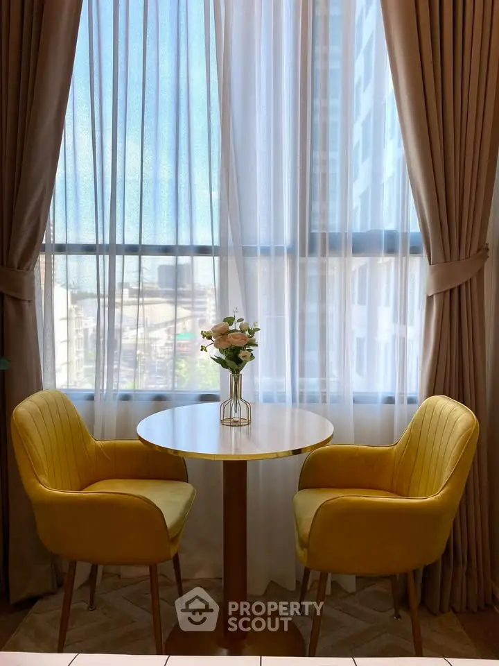 Charming dining nook with yellow chairs and elegant curtains, perfect for cozy meals and intimate conversations.