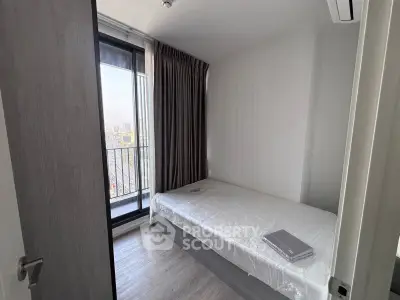 Cozy bedroom with balcony view in modern apartment