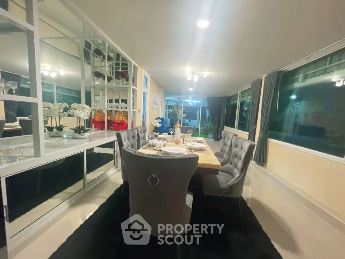 Luxurious dining room with elegant decor and large windows for natural light.