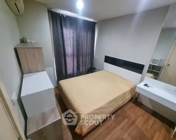 Cozy bedroom with modern furnishings and wooden flooring