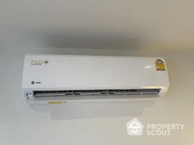 Modern wall-mounted air conditioning unit in a sleek interior setting.